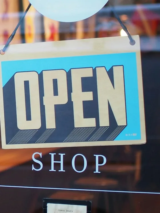 Open sign in a retail storefront window representing e-commerce and retail