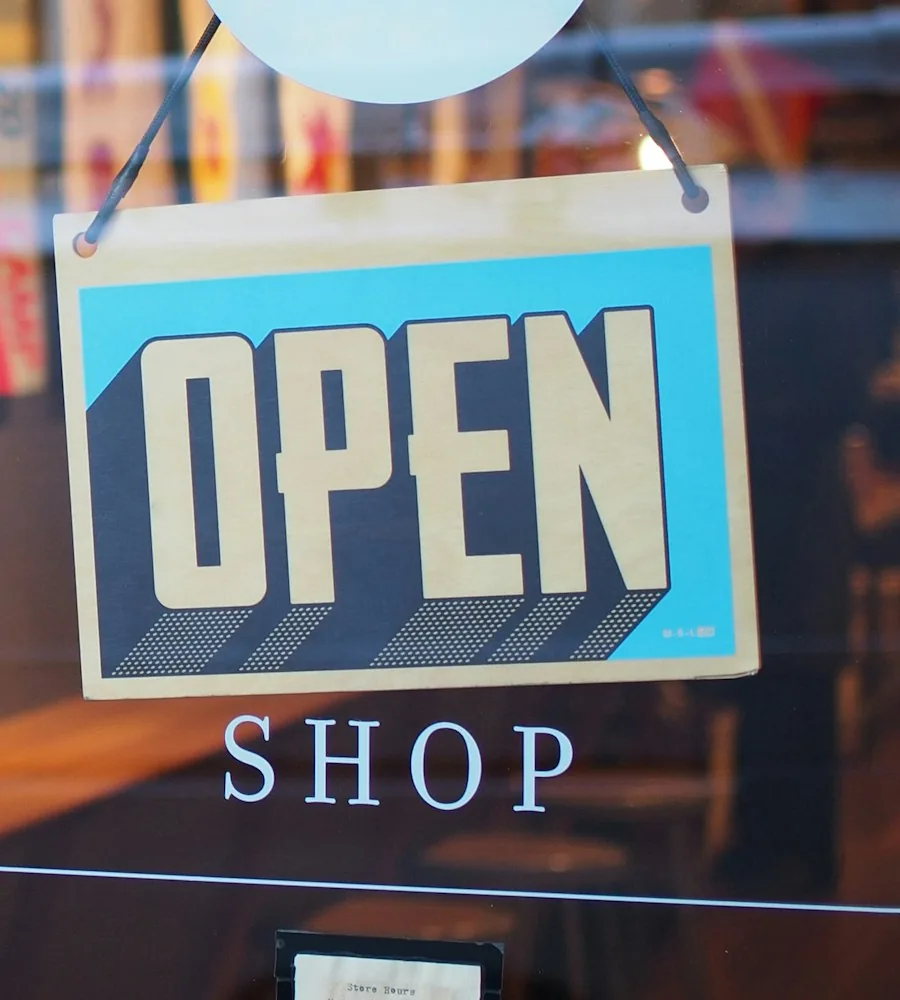 Retail store owner reviewing an online store on a laptop