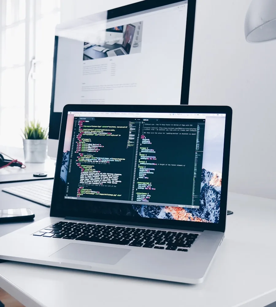 Developer writing clean HTML and CSS code on a laptop screen