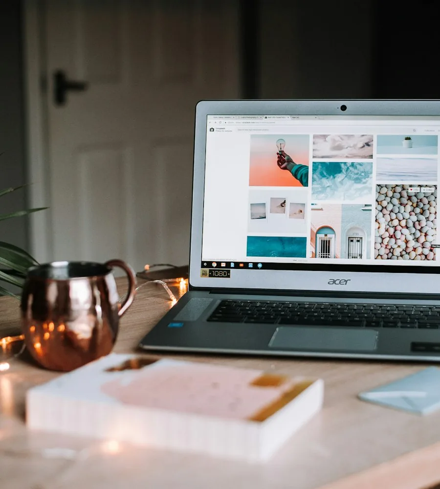 Designer sketching brand and storefront layout concepts on paper alongside a laptop