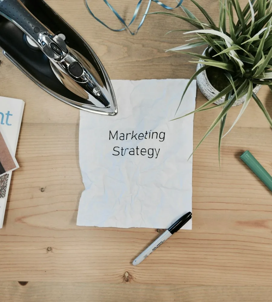 Marketer setting up ad campaign structure and audience targeting on a laptop